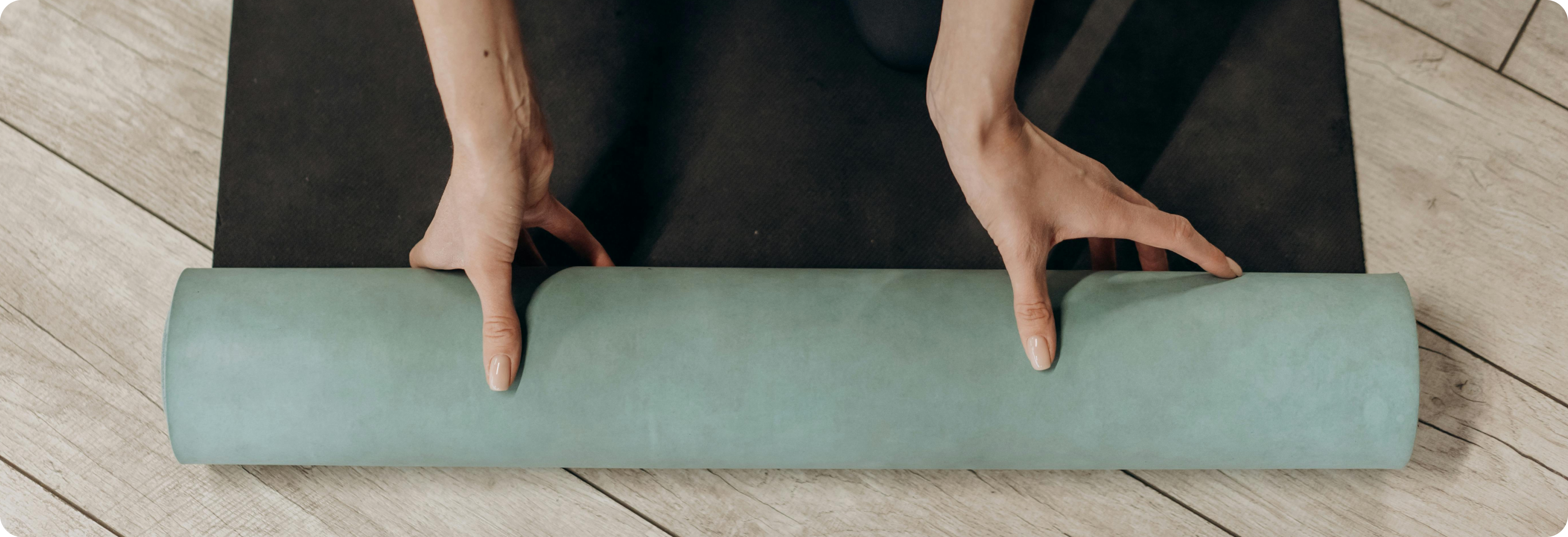 Girl rolling out a yoga mat